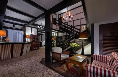 a living room with a chandelier and a staircase at The Lakehouse Cameron Highlands in Ringlet
