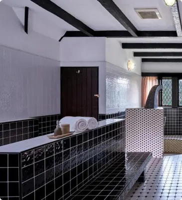 a bathroom with a black and white tiled wall at The Lakehouse Cameron Highlands in Ringlet