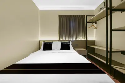 a bedroom with a white bed and a window at Collection O GHC Near Penang Street Art Formerly Queen City Hotel in George Town