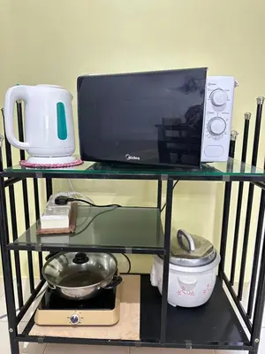 a glass shelf with a computer on top of it at Triple J in Cameron Highlands