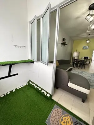a living room with a couch and a green carpet at Triple J in Cameron Highlands