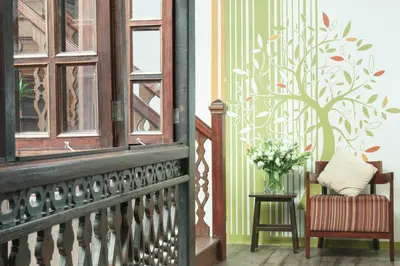 a room with a chair and a vase of flowers at Carnarvon House in George Town