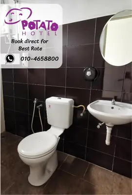 a bathroom with a toilet and a sink at Potato Hotel in Taiping