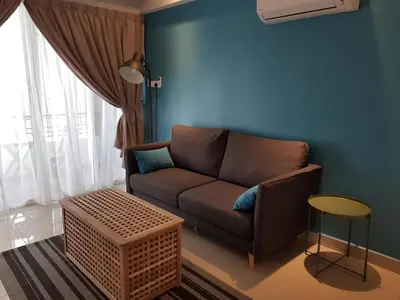 a living room with a couch and a blue wall at Mike's Place @ The Majestic Ipoh in Ipoh