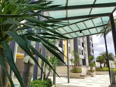 a glass canopy over a courtyard with palm trees at Mike's Place @ The Majestic Ipoh in Ipoh