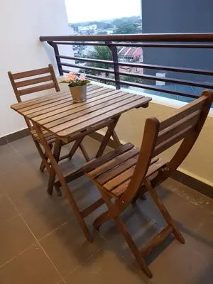 a wooden table and chairs sitting on a balcony at Mike's Place @ The Majestic Ipoh in Ipoh