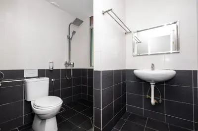 a bathroom with a toilet and a sink at BG Business Hotel in Bukit Mertajam