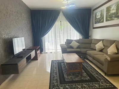 a living room with a couch and a tv at Ar Rayyan Apartments Prima Villa 3D8 in Cameron Highlands