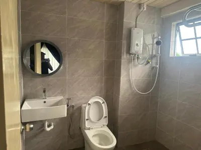 a bathroom with a toilet and a sink and a mirror at Ar Rayyan Apartments Prima Villa 3D8 in Cameron Highlands