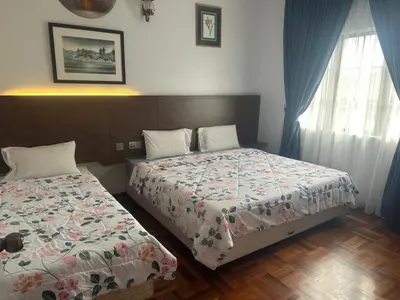 a bedroom with two beds and a window at Ar Rayyan Apartments Prima Villa 3D8 in Cameron Highlands