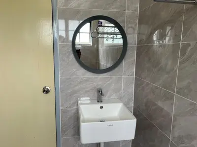 a bathroom with a white sink and a mirror at Ar Rayyan Apartments Prima Villa 3D8 in Cameron Highlands