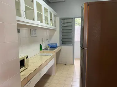 a kitchen with white cabinets and a stainless steel refrigerator at Ar Rayyan Apartments Prima Villa 3D8 in Cameron Highlands