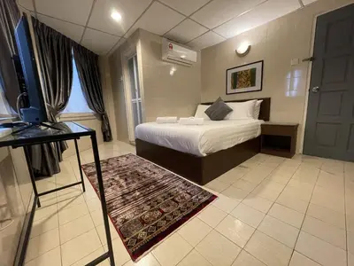 a bedroom with a bed and a tv in it at Barrack Street Hotel in Taiping