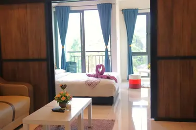 a bedroom with a bed with a pink towel on it at ATS Cameron Hotel & Apartments in Cameron Highlands