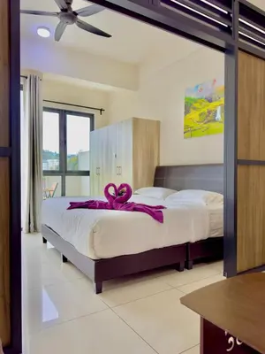 a bedroom with a bed with a ribbon on it at ATS Cameron Hotel & Apartments in Cameron Highlands