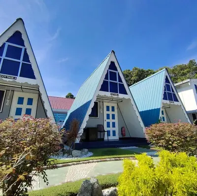 a house with triangular roofs with a yard at Nipah Guesthouse Pangkor in Pangkor