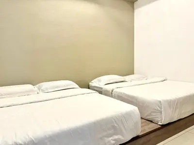 three beds in a room with white sheets at Themework Homestay@Cameron Highlands in Cameron Highlands