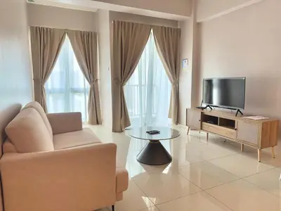 a living room with a tv and a chair and a table at Themework Homestay@Cameron Highlands in Cameron Highlands