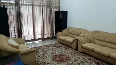 a living room with two couches and a couch at Homestay Ahmad Kuala Kangsar in Kuala Kangsar