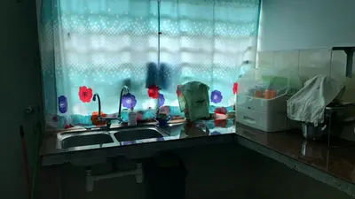 a kitchen counter with a sink and a window at Homestay Ahmad Kuala Kangsar in Kuala Kangsar