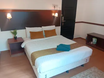 a bedroom with a large bed in a room at Melur Inn in Cameron Highlands