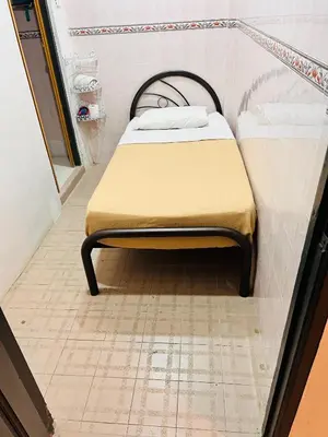 a bed sitting in a corner of a room at KRS Pines GuestHouse in Cameron Highlands