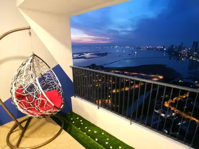 a balcony with a chair and a view of the water at The Landmark Pulau Andaman Gurney Bay View in George Town