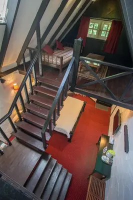 an overhead view of a room with a staircase and a bed at The Bala's Holiday Chalet in Cameron Highlands