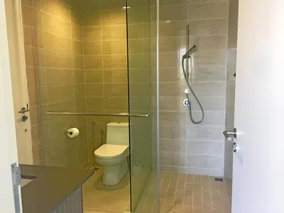 a bathroom with a toilet and a glass shower at By The Sea Suite,Batu Ferringhi in Batu Ferringhi