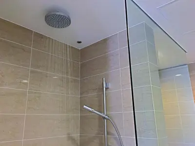 a shower with a glass door in a bathroom at By The Sea Suite,Batu Ferringhi in Batu Ferringhi