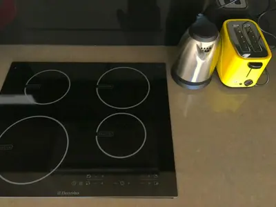 a counter top with a blender and a remote control at By The Sea Suite,Batu Ferringhi in Batu Ferringhi