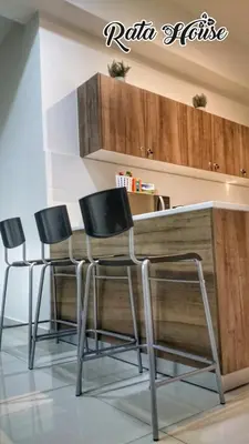 a kitchen with four chairs around a wooden table at Rata House in Cameron Highlands