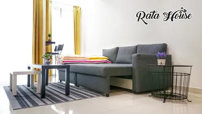 a living room with a couch and two tables at Rata House in Cameron Highlands