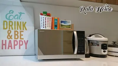 a microwave on a counter next to a coffee maker at Rata House in Cameron Highlands