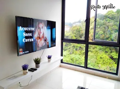 a living room with two windows and a flat screen tv at Rata House in Cameron Highlands