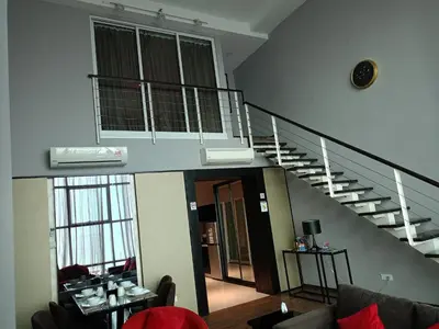 a living room with a staircase in a house at Urbano Luxury Maritime Suite in George Town