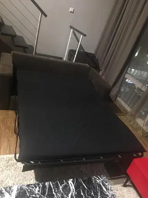a black couch in a living room with a window at Urbano Luxury Maritime Suite in George Town