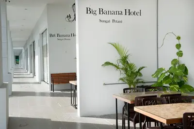 a hallway with tables and chairs in a building at Big Banana Hotel, Sg Petani in Sungai Petani