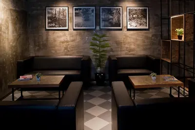 a restaurant with couches and tables and pictures on the wall at Big Banana Hotel, Sg Petani in Sungai Petani