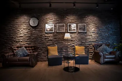 a living room with couches and a brick wall at Big Banana Hotel, Sg Petani in Sungai Petani