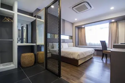 a bedroom with a bed and a desk and a mirror at Wifi Boutique Hotel in George Town