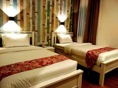 a hotel room with two beds in a room at Wifi Boutique Hotel in George Town