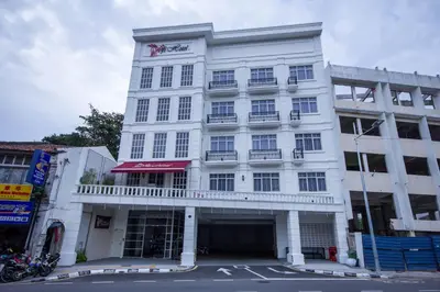 a white building with a balcony on a street at Wifi Boutique Hotel in George Town