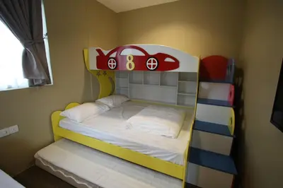 a childs bunk bed with a toy car on it at Shamrock Greenhill in Ipoh