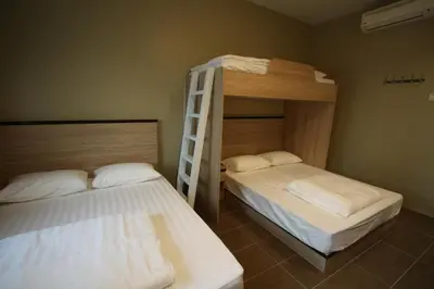 a bedroom with two bunk beds and a ladder at Shamrock Greenhill in Ipoh