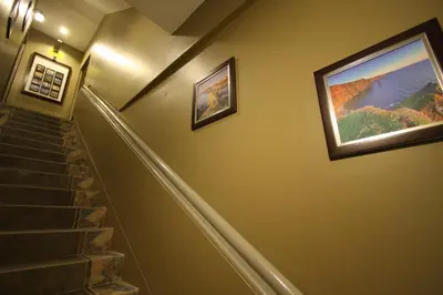 a staircase with two pictures on the wall and a painting at Shamrock Greenhill in Ipoh