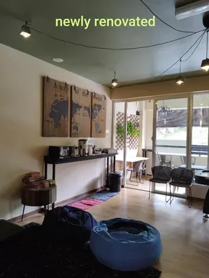 a living room with a couch and a table at Sleepbox Hotel in Cameron Highlands