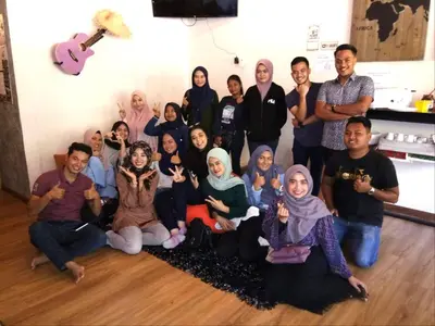 a group of people posing for a picture in a room at Sleepbox Hotel in Cameron Highlands