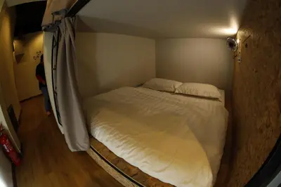 a small bedroom with a bed in a room at Sleepbox Hotel in Cameron Highlands