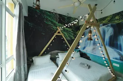 two beds in a room with a painting on the wall at \u5bb6 Majestic Ipoh in Ipoh